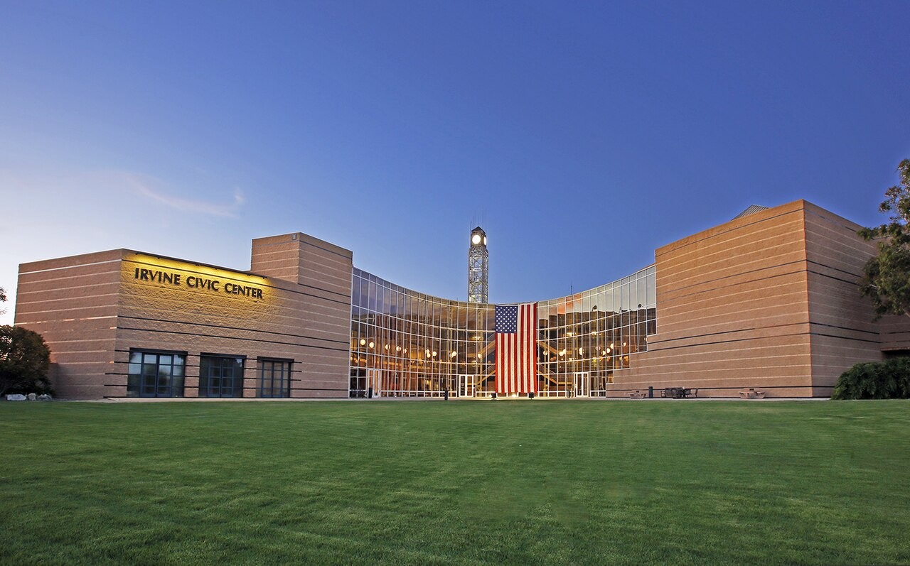 Irvine Civic Center at dusk, with the American flag displayed on the building.